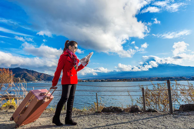 tourist-with-baggage-map-fuji-mountain-kawaguchiko-japan_335224-7